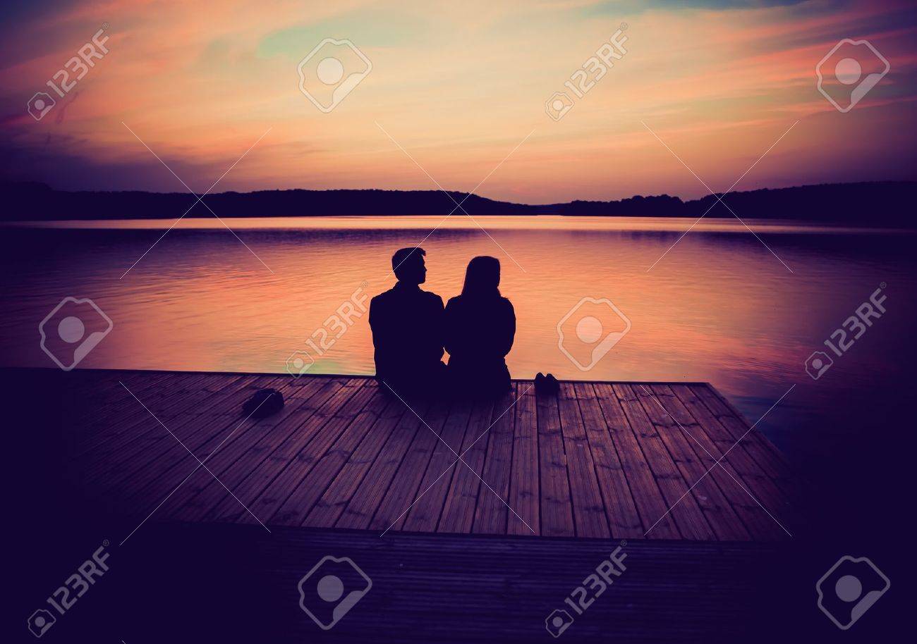 Silhouettes Of Hugging Couple Against The Sunset Sky. Vintage Photo. Stock  Photo, Picture and Royalty Free Image. Image 38511788., image size:1300x914