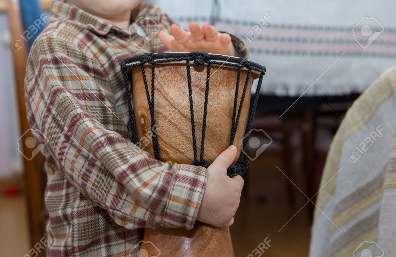 Small child playing on drum. Little caucasian boy and drum. Hands close up - 49470336 Small child playing on drum. Little caucasian boy and drum. Hands close up - 49470336