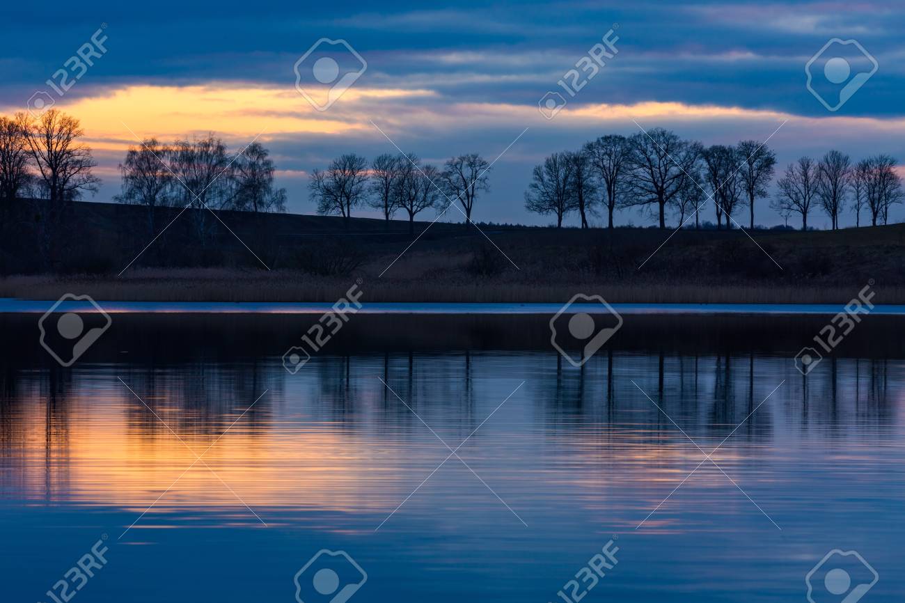 日没の風景後湖 木と水に映った空湖の対岸のクローズ アップ 美しい風景です の写真素材 画像素材 Image