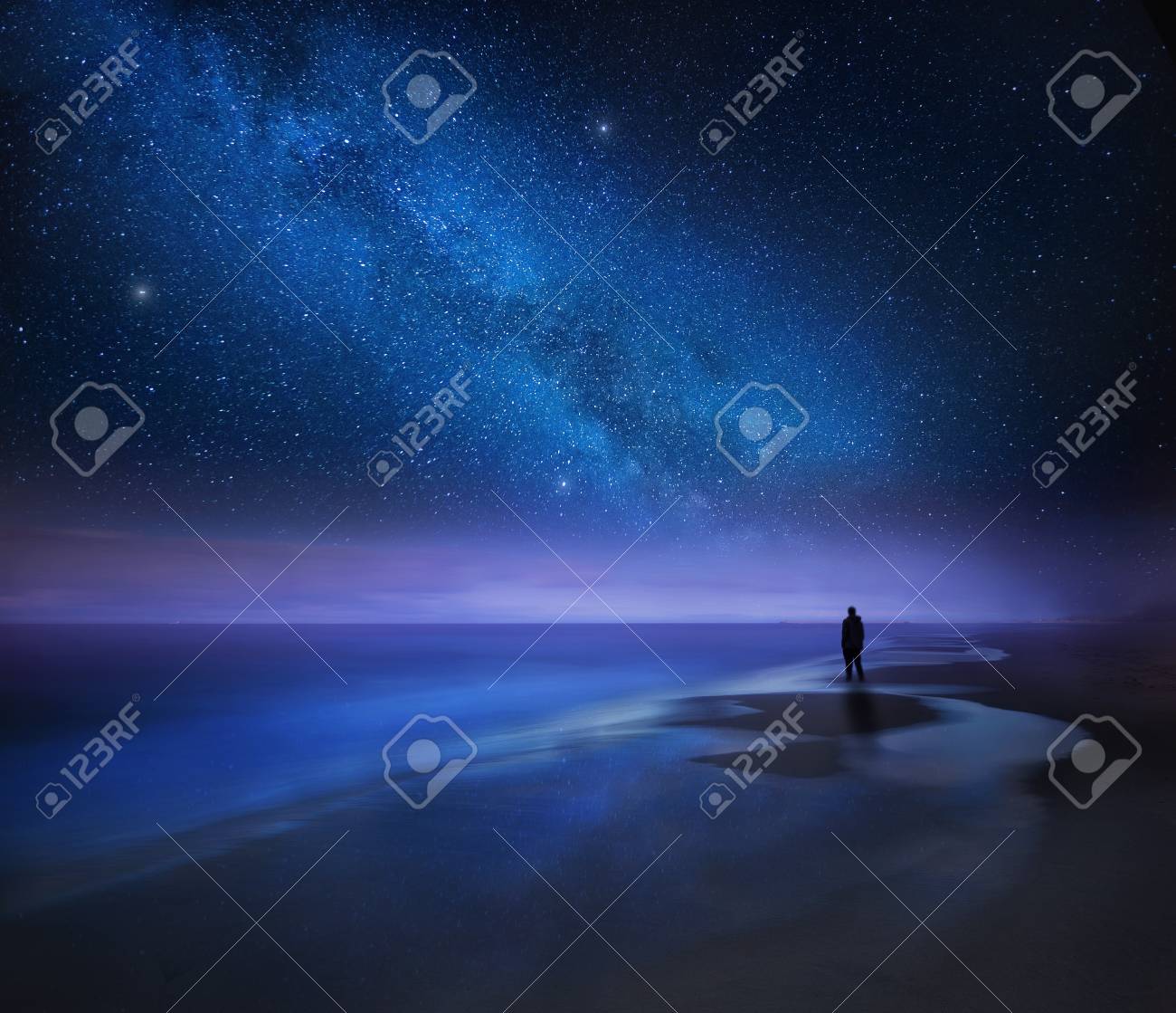 Starry Night Sky Over Sea And Beach With Man Silhouette Man