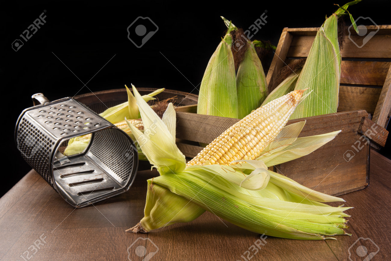 Festa Junina in Brazil, Green corn, grater and a sieve on a table, selective focus. - 166038509 Festa Junina in Brazil, Green corn, grater and a sieve on a table, selective focus. - 166038509