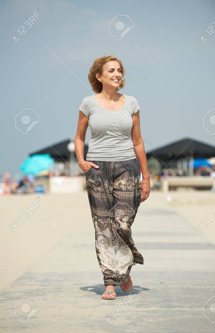 Portrait Of A Beautiful Older Woman Walking At The Beach Stock Photo 21644656 Portrait Of A Beautiful Older Woman Walking At The Beach Stock Photo 21644656