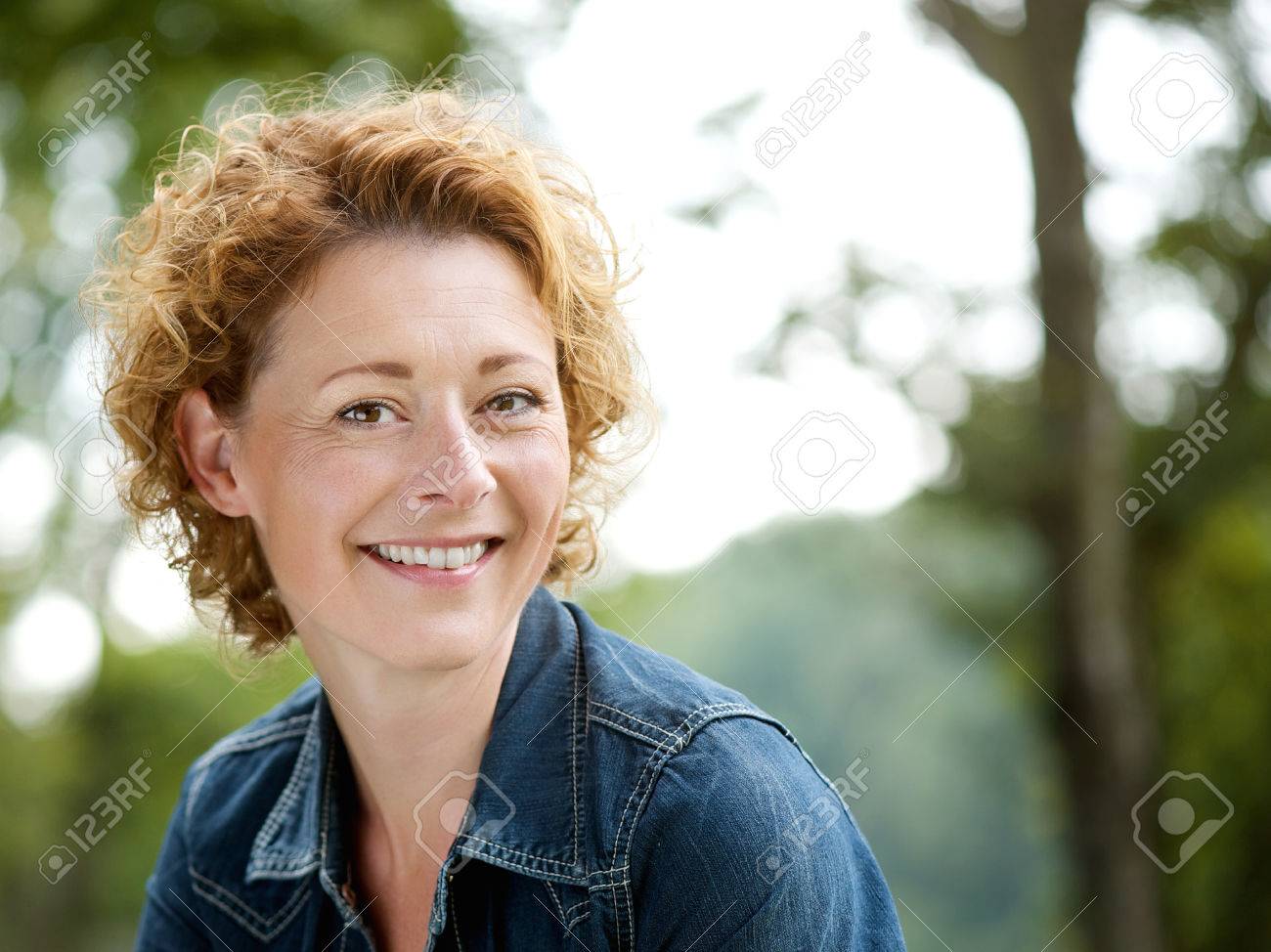 Portrait of a cheerful older woman smiling outdoors - 31788248 Portrait of a cheerful older woman smiling outdoors - 31788248