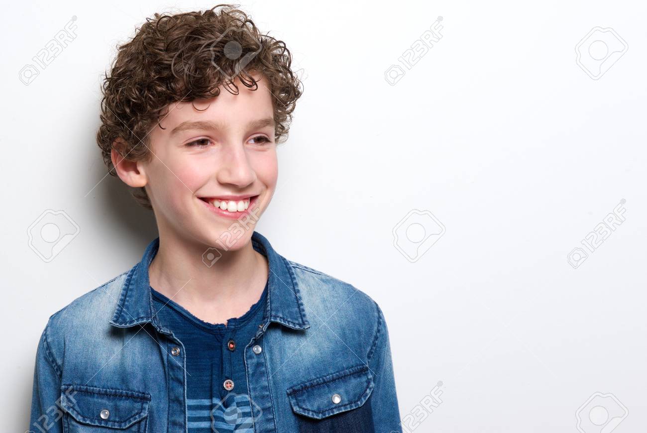Close Up Portrait Of A Cute Little Boy With Curly Hair Smiling