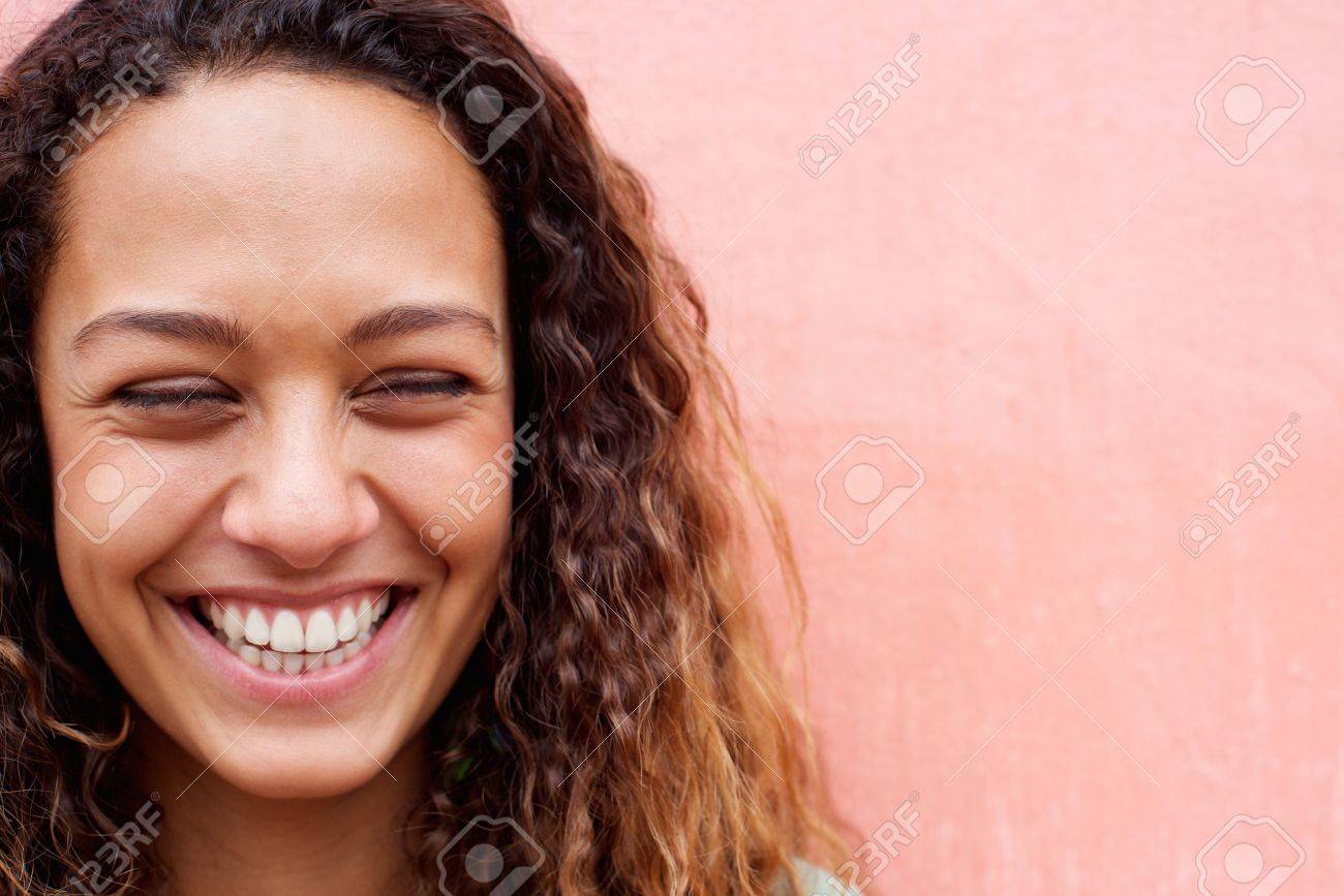 Close up portrait of laughing young woman with curly hair - 50593566 Close up portrait of laughing young woman with curly hair - 50593566