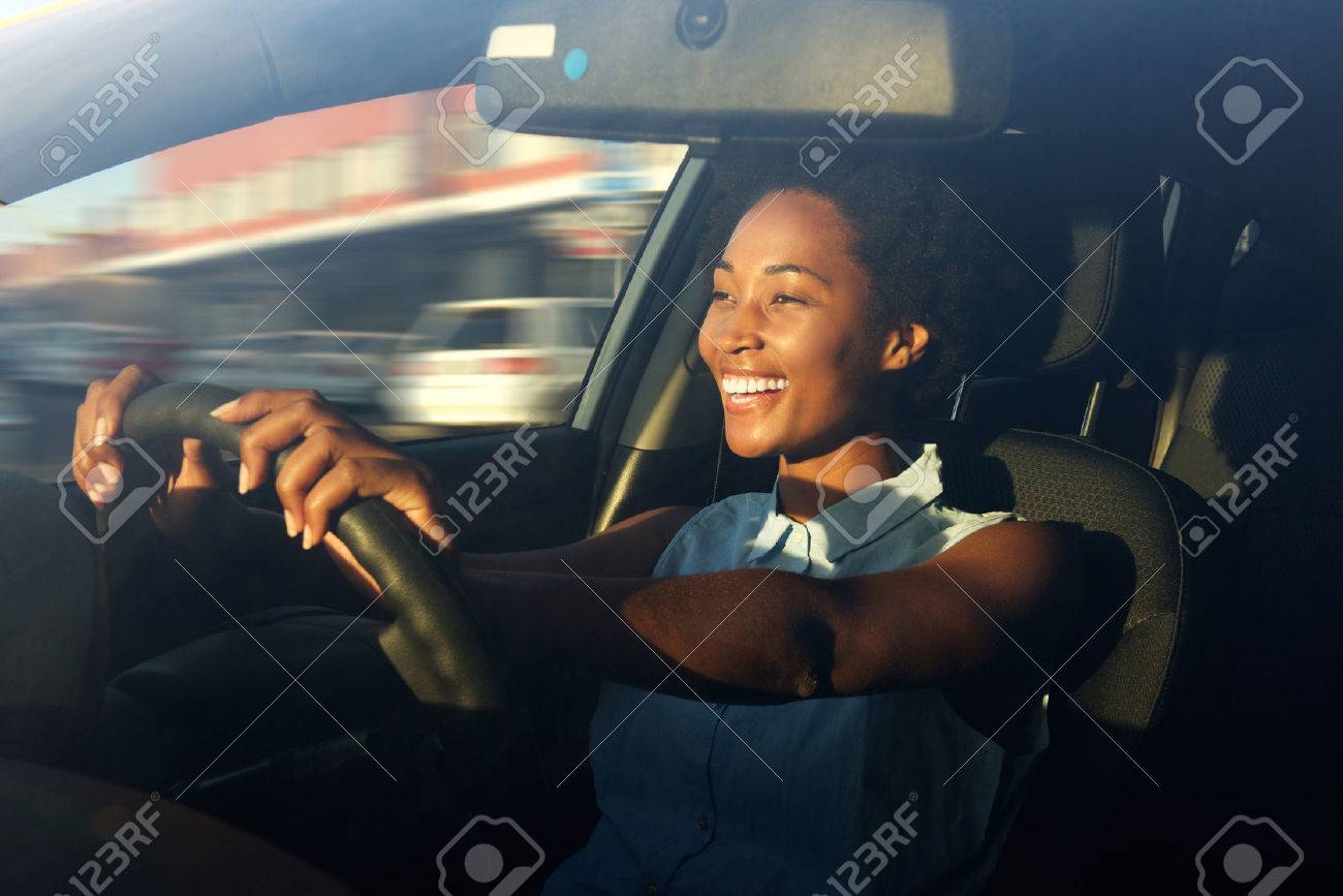 Portrait of smiling young african american woman driving a car - 60626289 Portrait of smiling young african american woman driving a car - 60626289