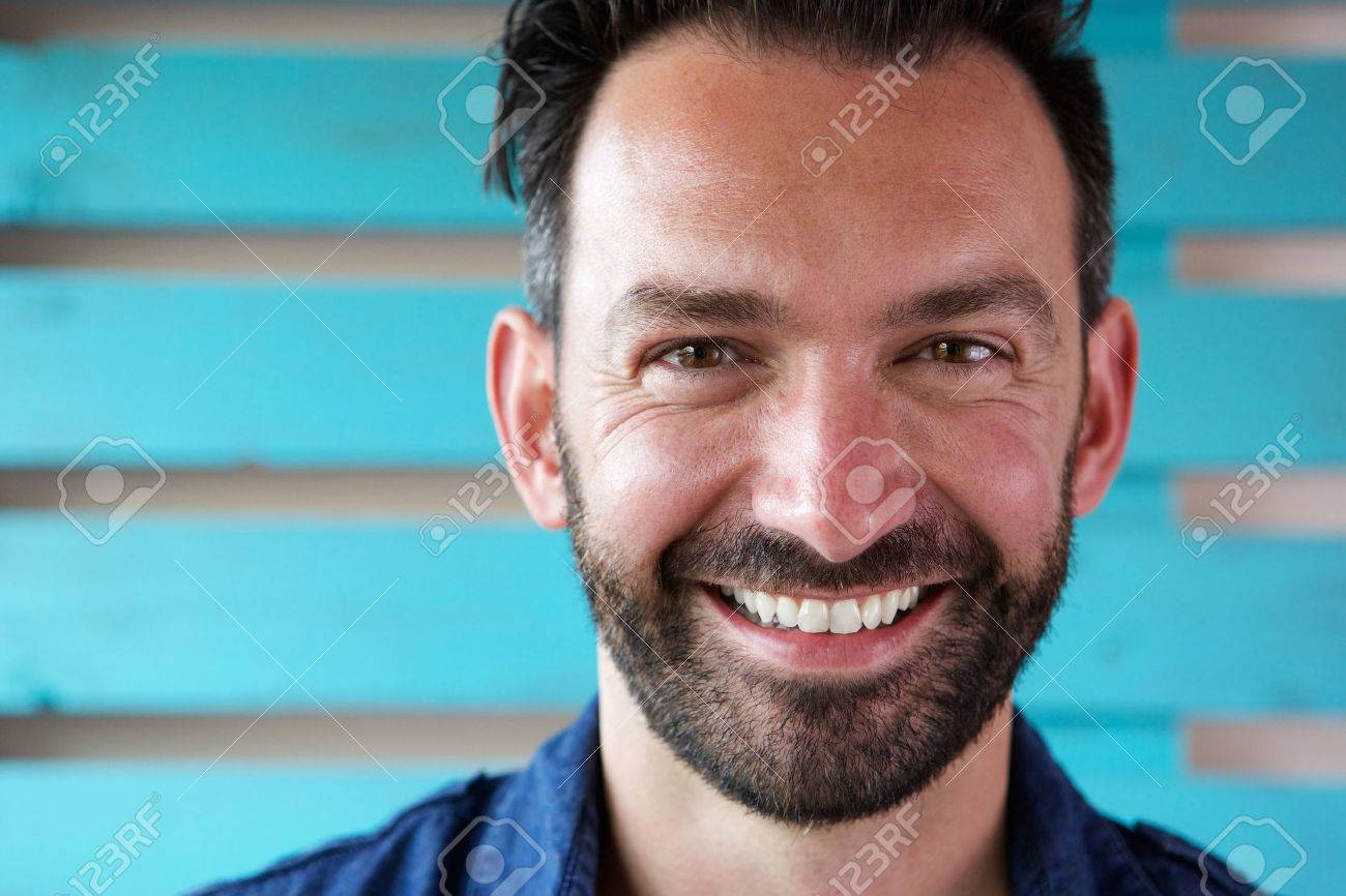 Close up portrait of handsome mature man with beard smiling - 63536572 Close up portrait of handsome mature man with beard smiling - 63536572