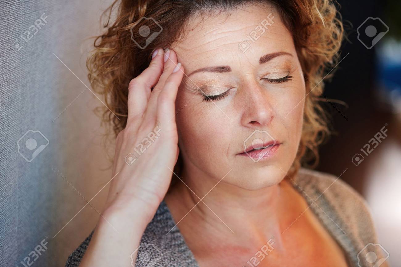 Close up portrait of older woman with hand to head in pain - 66843596 Close up portrait of older woman with hand to head in pain - 66843596