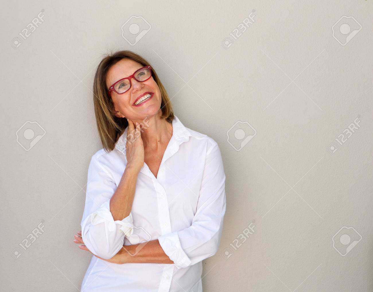 Portrait of smiling business woman with glasses looking up - 72409731 Portrait of smiling business woman with glasses looking up - 72409731