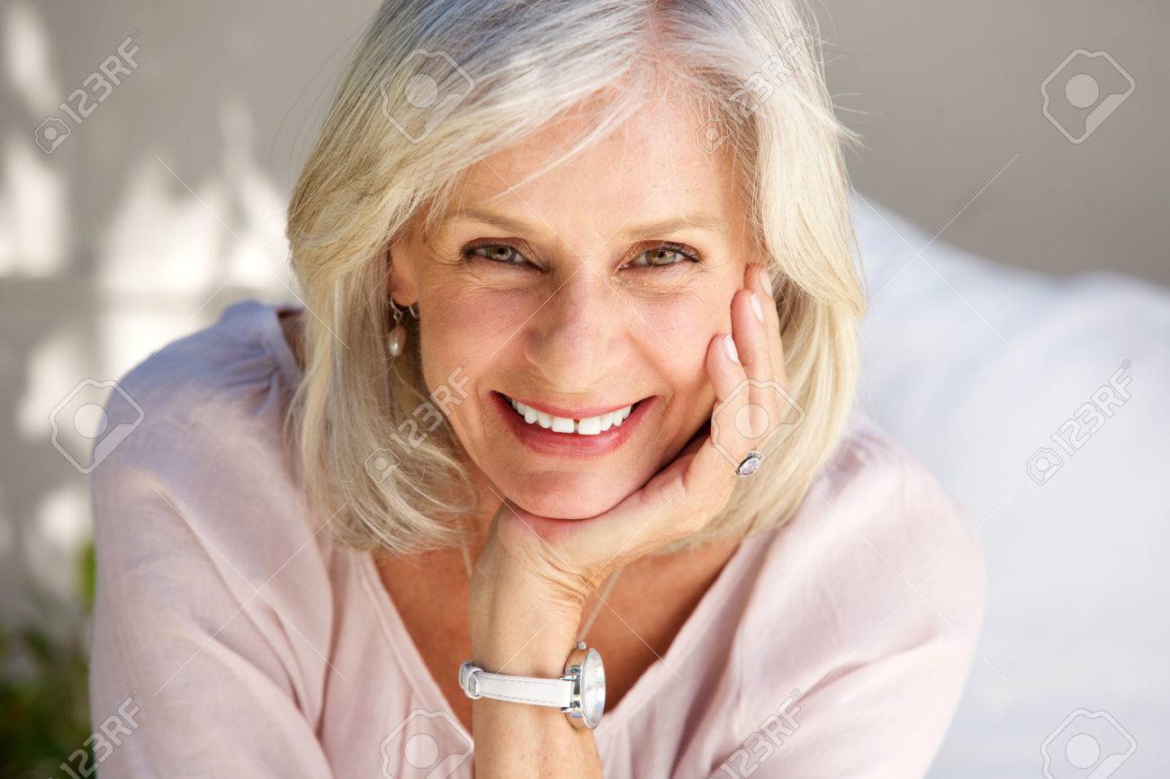 Close up portrait of mature woman smiling outside - 80539360 Close up portrait of mature woman smiling outside - 80539360