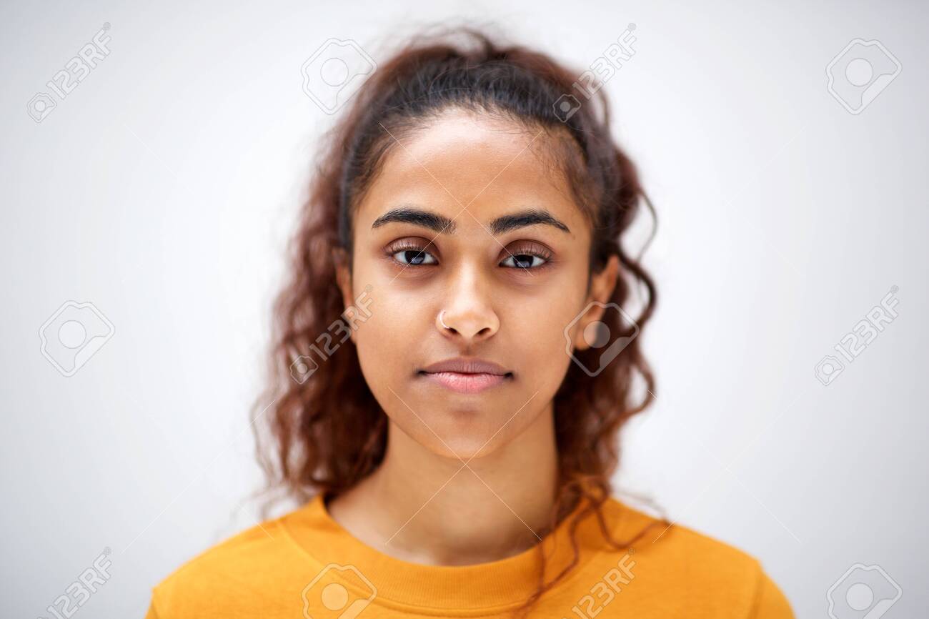 Close up horizontal front portrait of attractive young indian woman with serious expression on face - 130554555 Close up horizontal front portrait of attractive young indian woman with serious expression on face - 130554555