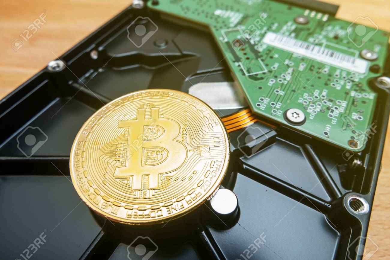 Cryptocurrency Golden Bitcoin On Hard Disk Drive With Blur Background Stock  Photo, Picture and Royalty Free Image. Image 104278930.