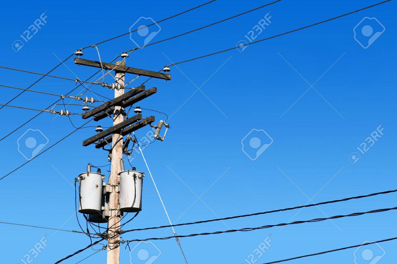 energy and technology electrical post by the road with power line
