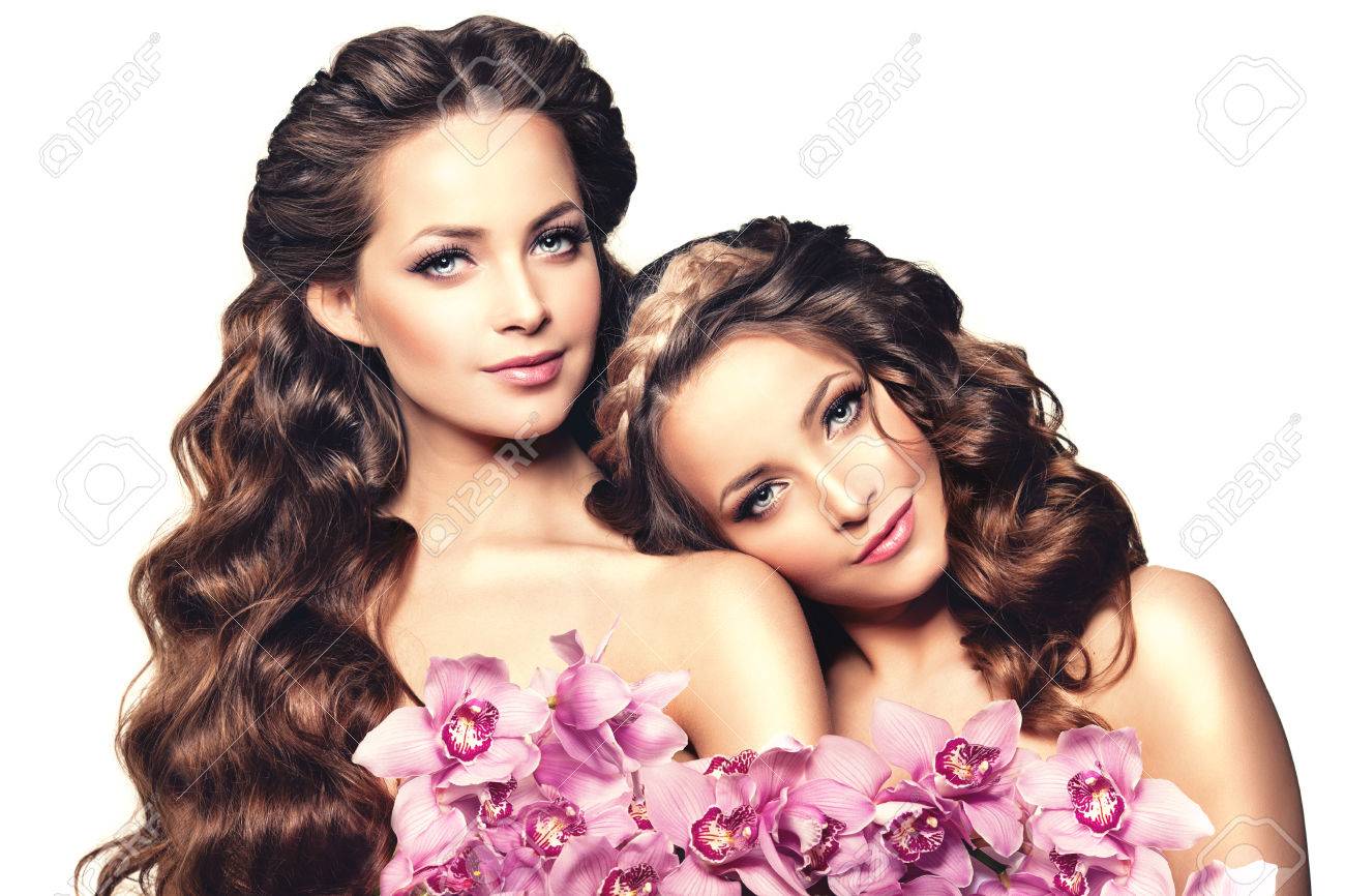 Two Beauty Young Women Luxury Long Curly Hair With Orchid Flower