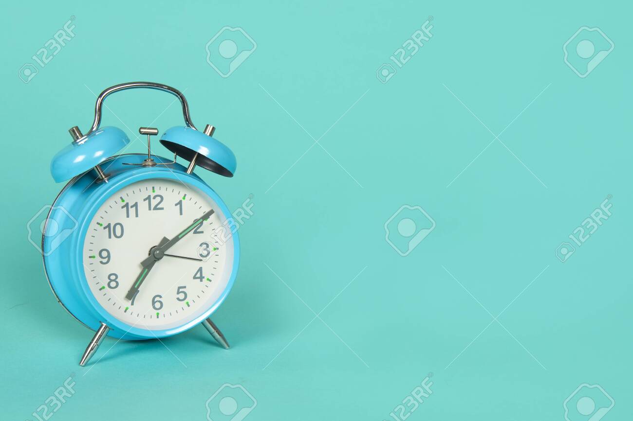 Blue retro clock on a blue background with copy space - 123558662 Blue retro clock on a blue background with copy space - 123558662