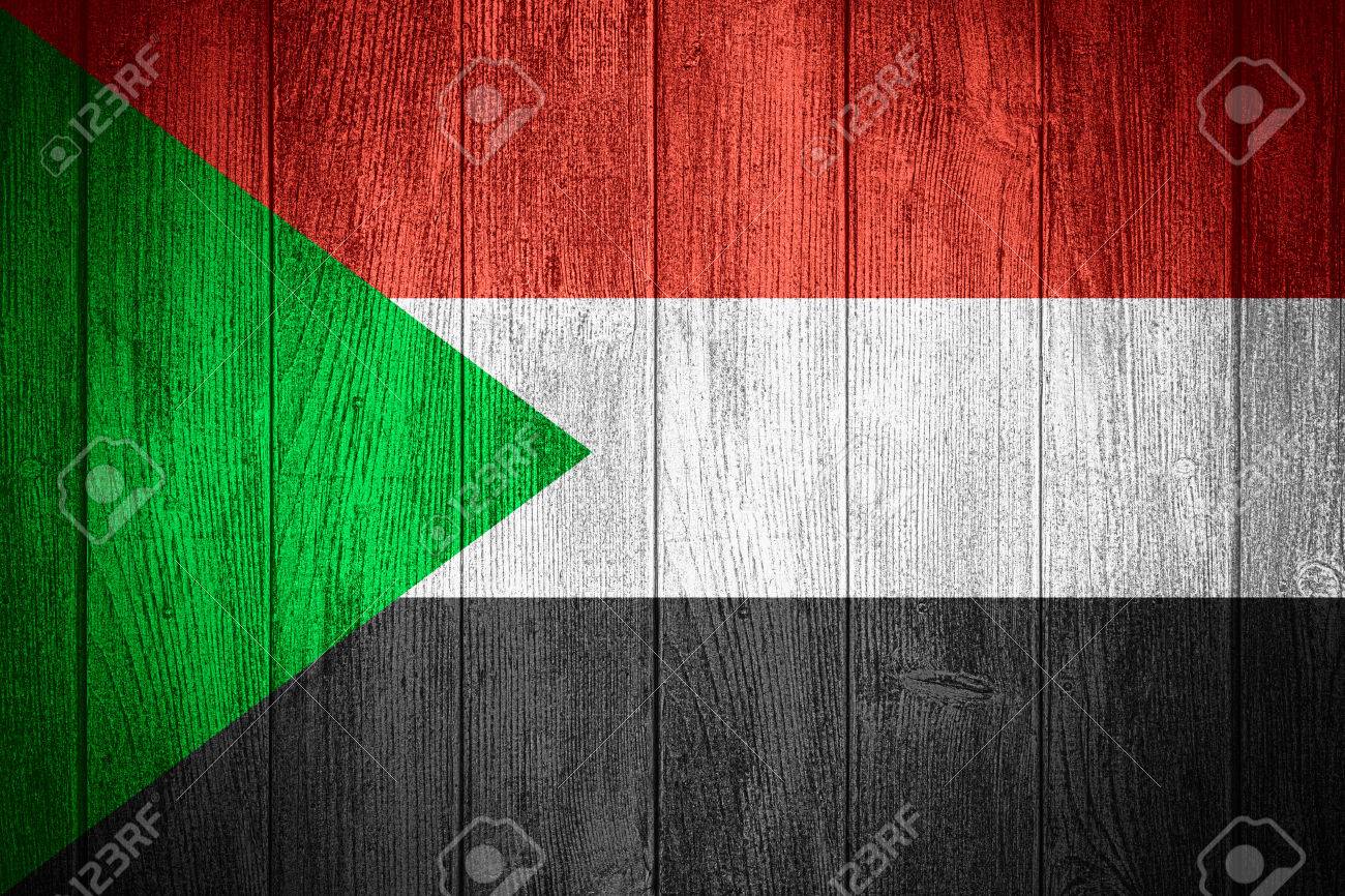 sudan flag or sudanese banner on wooden boards background stock