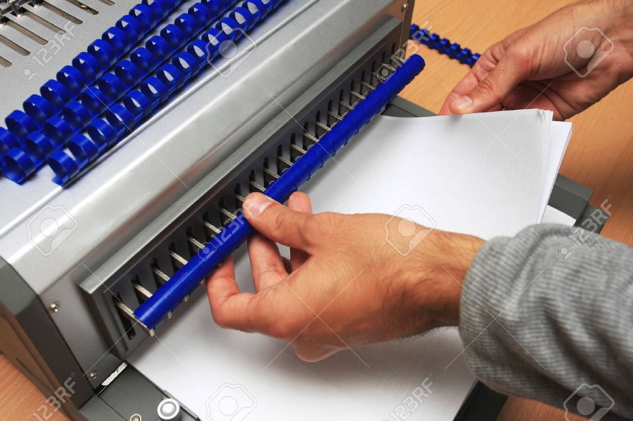 Gray Binding machine with man who works on it - 52366421 Gray Binding machine with man who works on it - 52366421