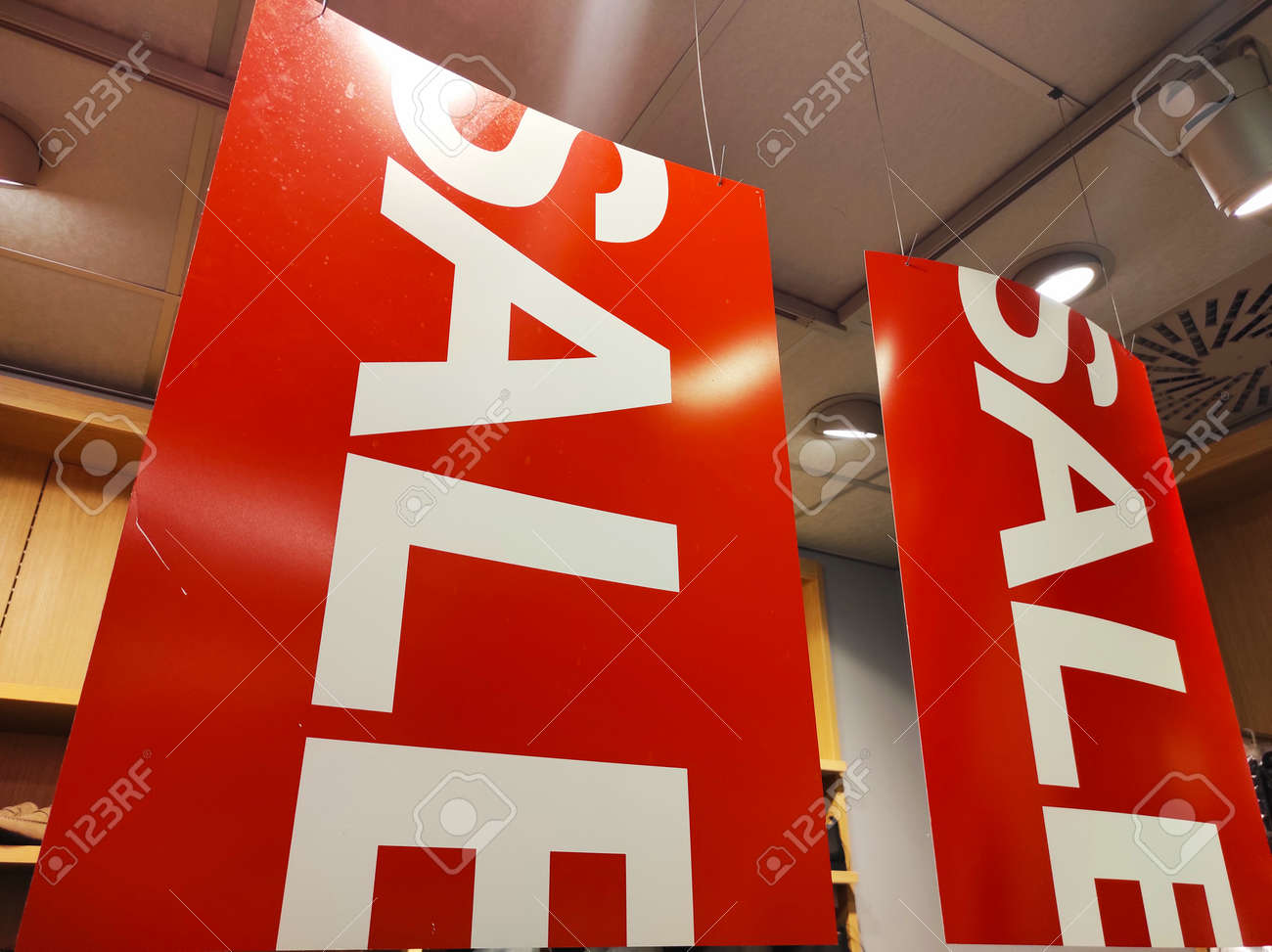 Sale signs in a clothing store. - 155645483 Sale signs in a clothing store. - 155645483