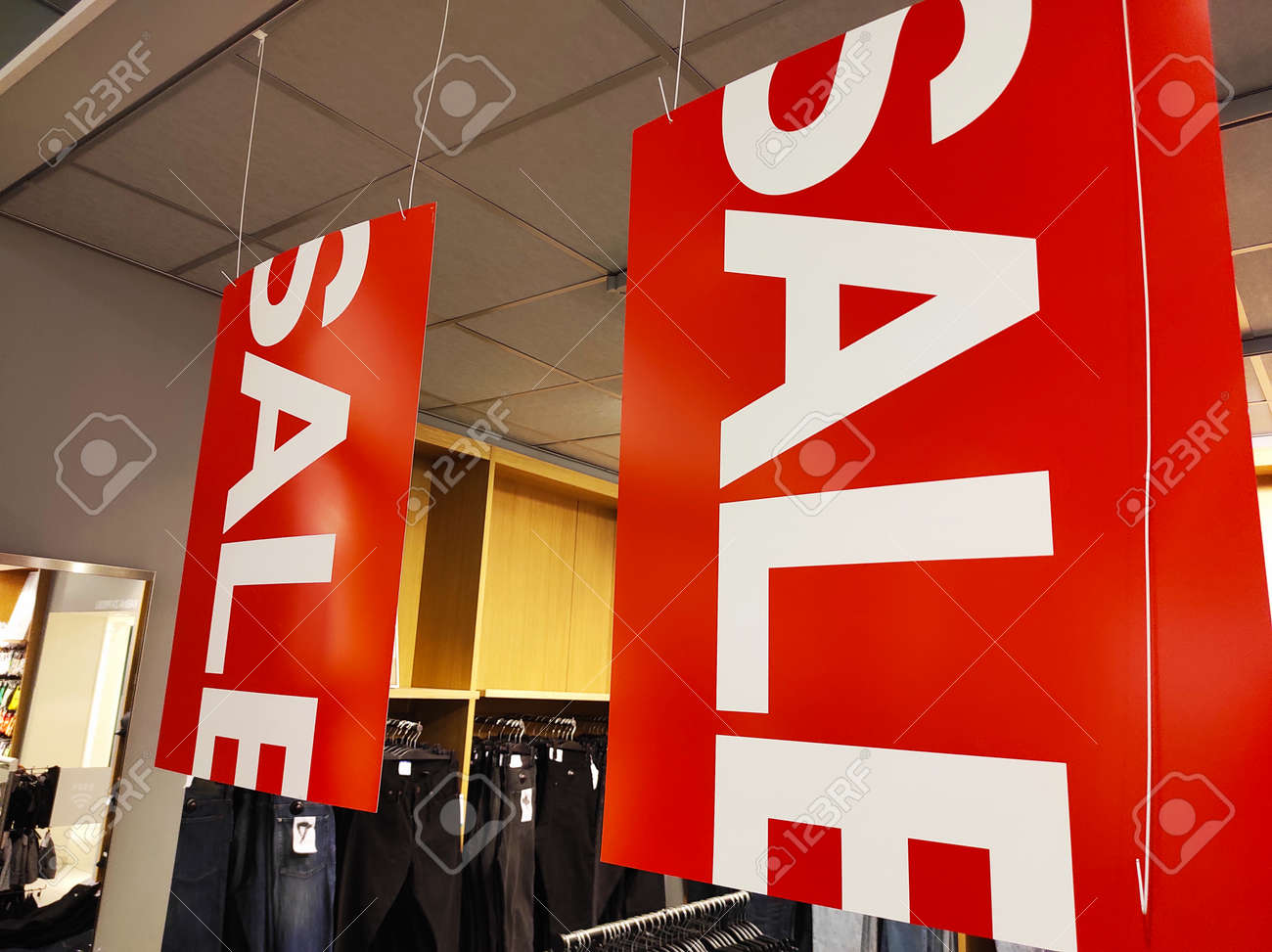 Sale signs in a clothing store. - 155803853 Sale signs in a clothing store. - 155803853