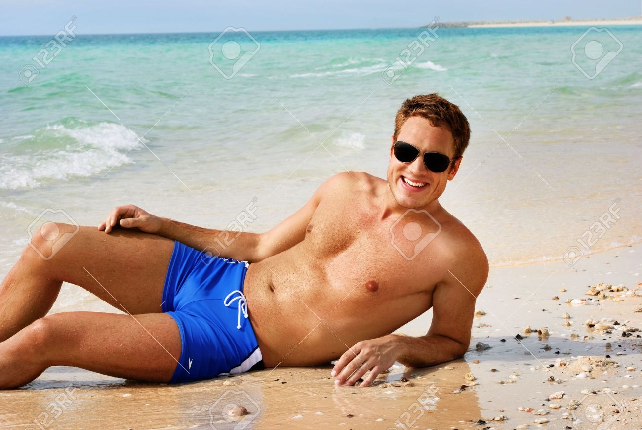 Happy Smiling Man Laying On The Beach Stock Photo 10163427 Happy Smiling Man Laying On The Beach Stock Photo 10163427
