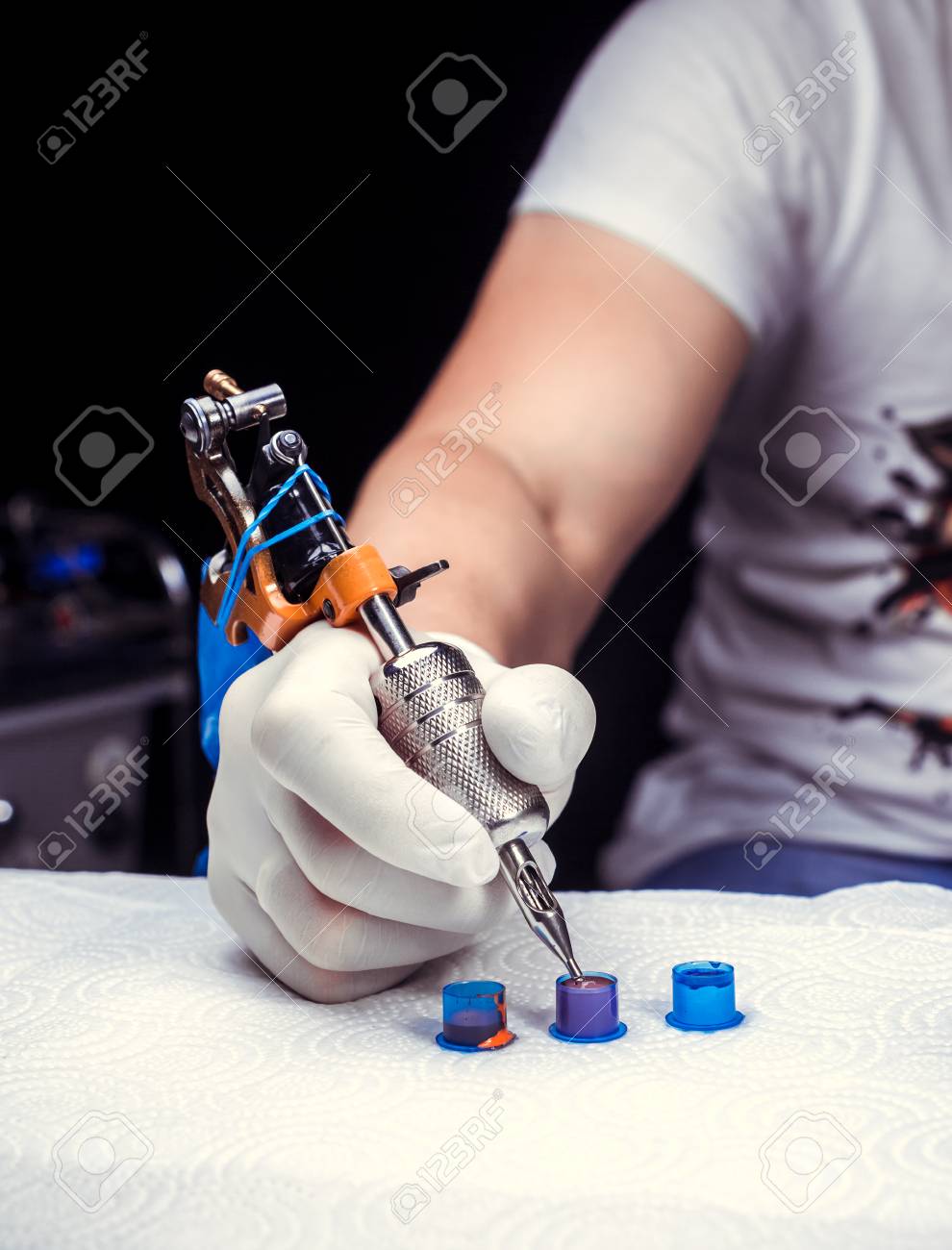 Hand Of A Tattooist Holding The Tattoo Gun Stock Photo Picture And Royalty Free Image Image
