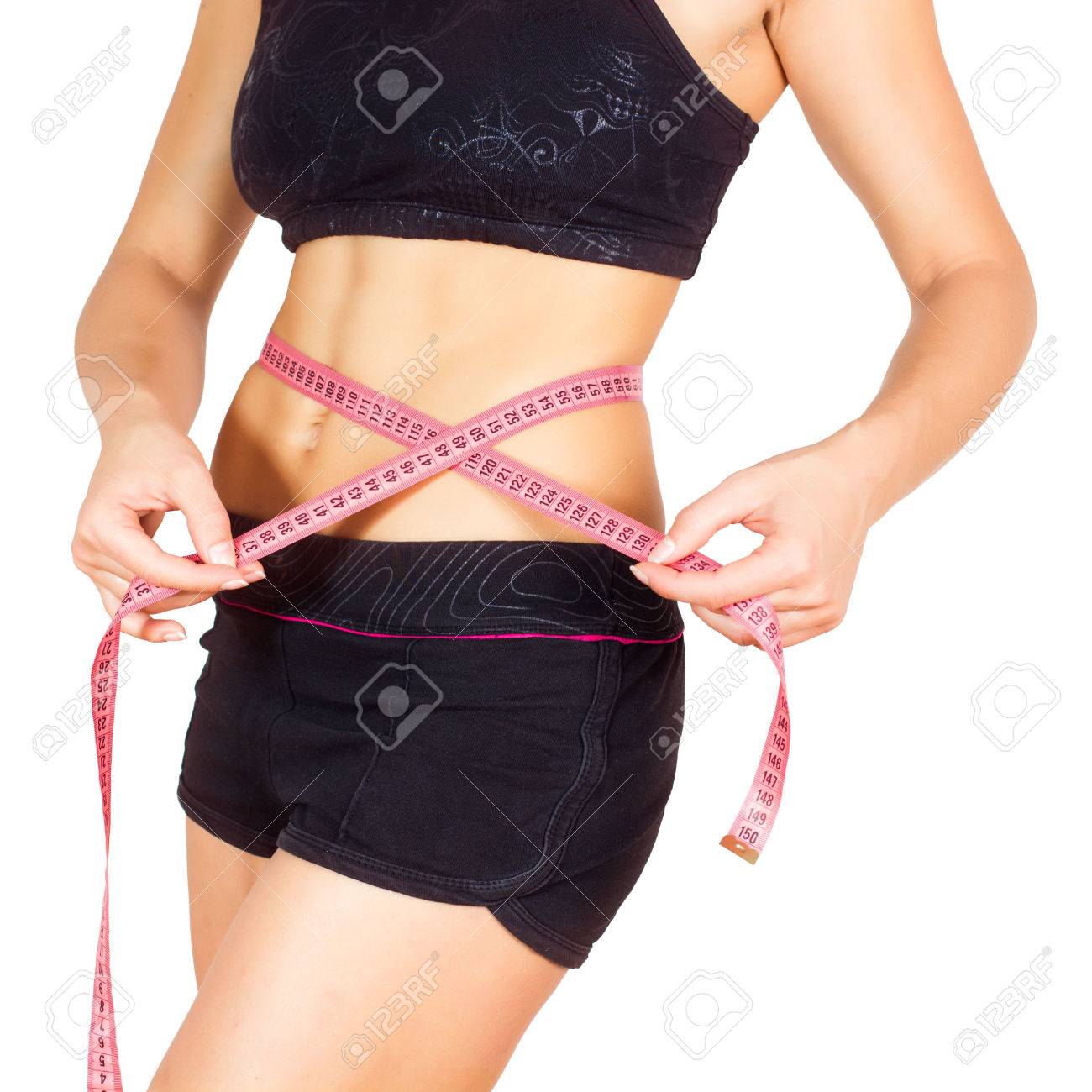 巻尺と彼女の細いウエストを測定焼き芋と健康的なボディを持つスリムな女性 の写真素材 画像素材 Image
