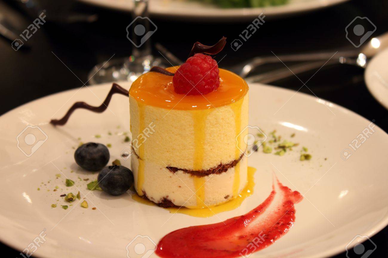 Delicious Mango Mousse Cake Topped With Raspberries And Chocolate Stock Photo Picture And Royalty Free Image Image