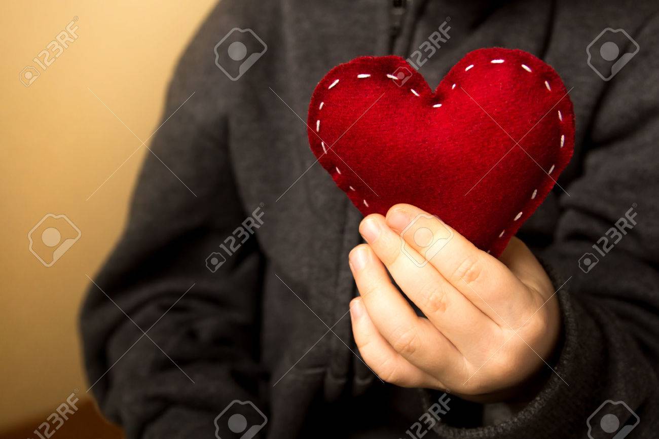 Red heart in child hands, gift, hand made valentine, close up, horizontal - 33237991 Red heart in child hands, gift, hand made valentine, close up, horizontal - 33237991