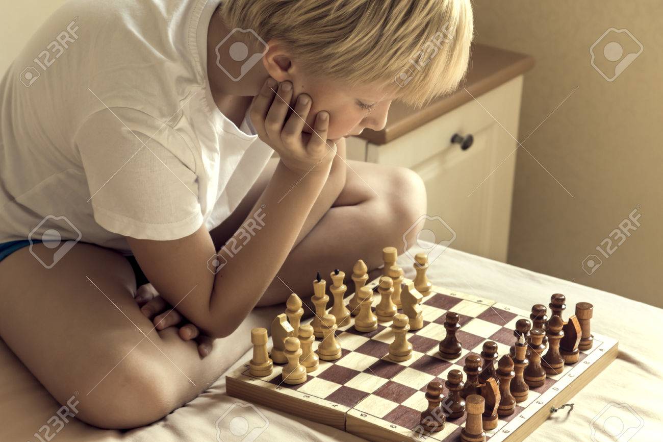Un Chico Inteligente Aprende a Jugar Ajedrez Solo En Su Habitación En Casa Foto de archivo - Imagen de escuela, concepto: 230349380