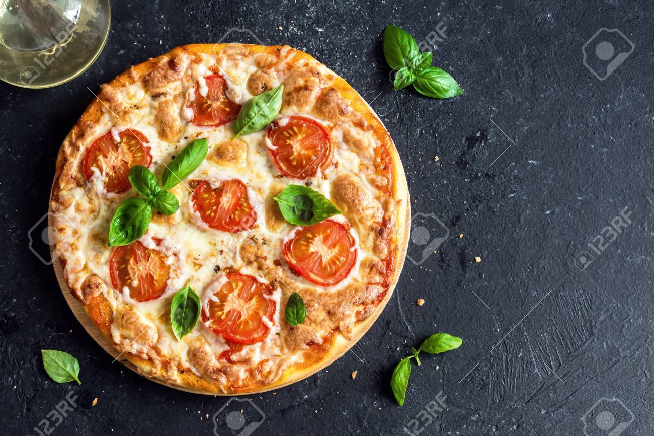 Pizza Margherita On Black Stone Background Top View Pizza Margarita With Tomatoes Basil And Mozzarella Cheese Close Up Stock Photo Picture And Royalty Free Image Image