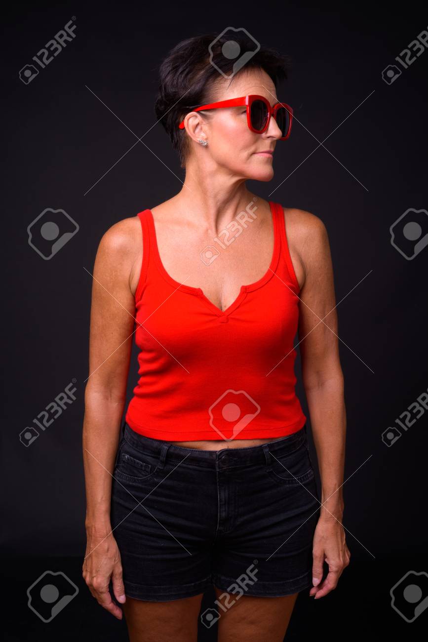 Mature Beautiful Woman With Short Hair Against Black Background