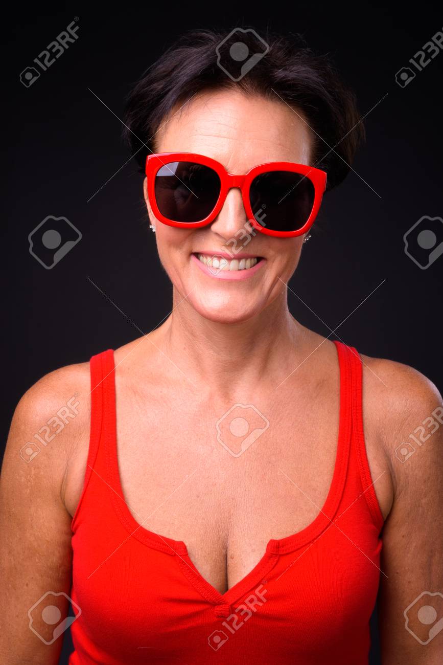 Mature Beautiful Woman With Short Hair Against Black Background Stock  Photo, Picture and Royalty Free Image. Image 108368930.