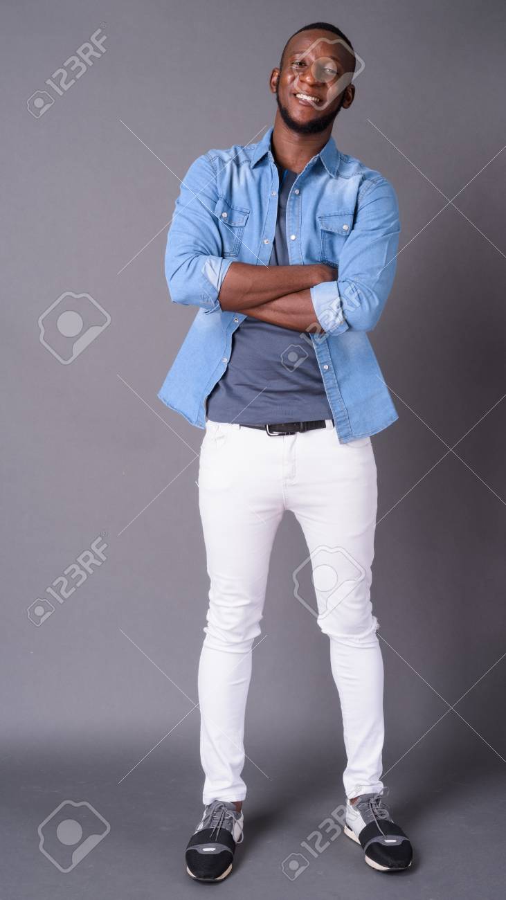 Young Handsome African Man With Short Hair Against Gray Backgrou