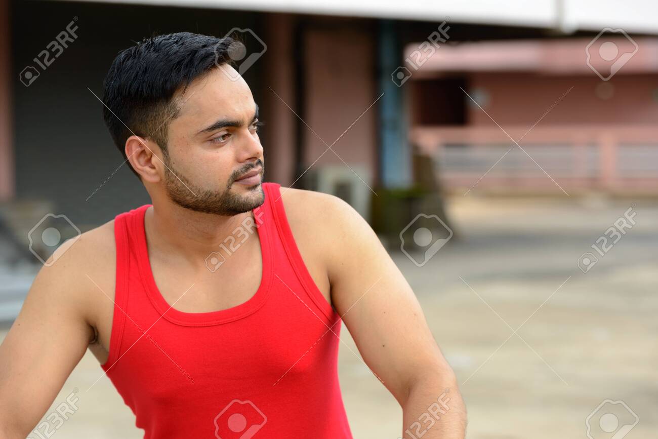 Young bearded Indian man thinking and looking away outdoors - 146007533 Young bearded Indian man thinking and looking away outdoors - 146007533