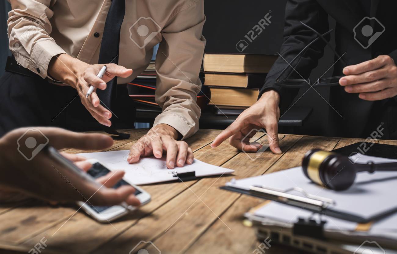 Teamwork of business lawyer meeting working hard about legal regislation in courtroom to help their customer. - 93009031 Teamwork of business lawyer meeting working hard about legal regislation in courtroom to help their customer. - 93009031