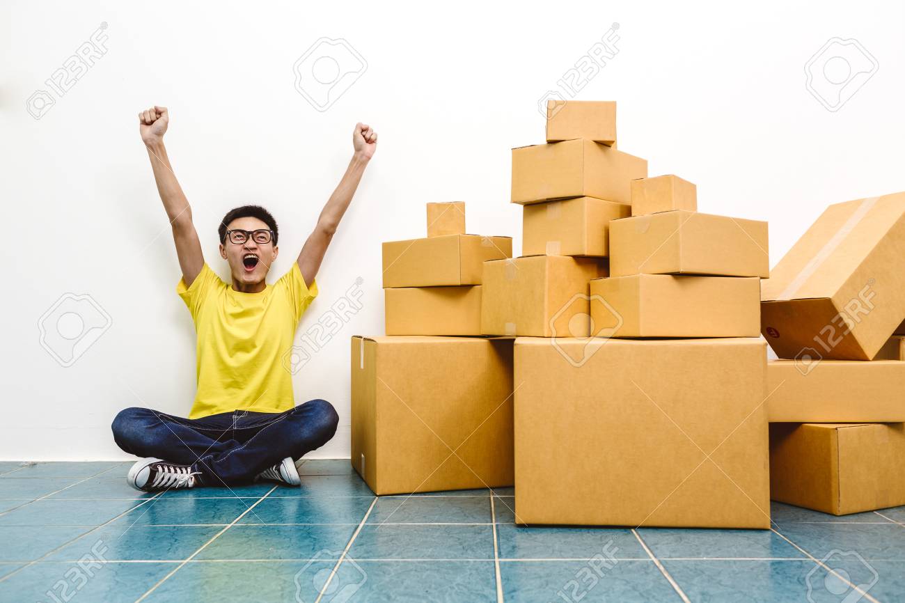 Asian man winner success as SME start up entrepreneur owner business with cardboard packaging box and delivery service. - 96593265 Asian man winner success as SME start up entrepreneur owner business with cardboard packaging box and delivery service. - 96593265