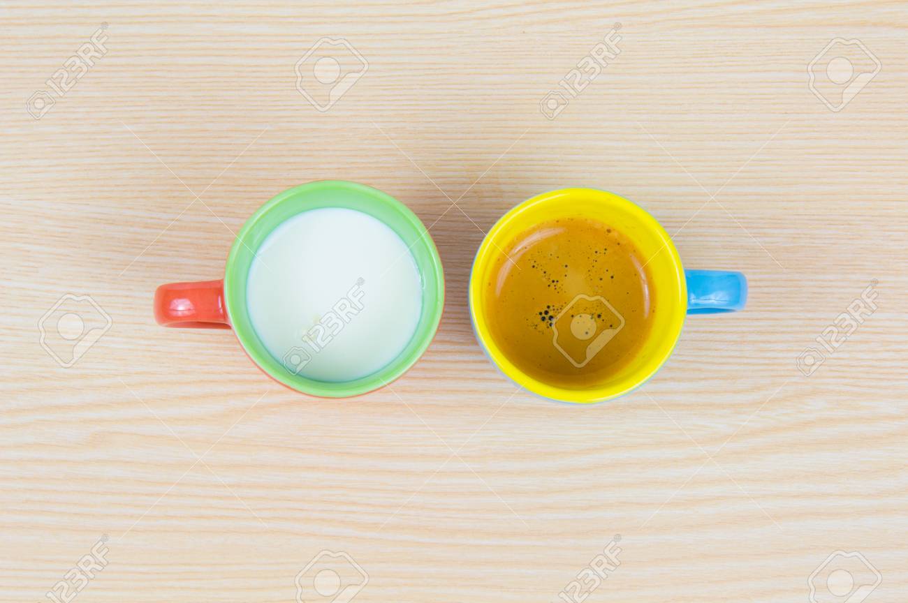 colorful coffee cups on wood board closeup with coffee and milk