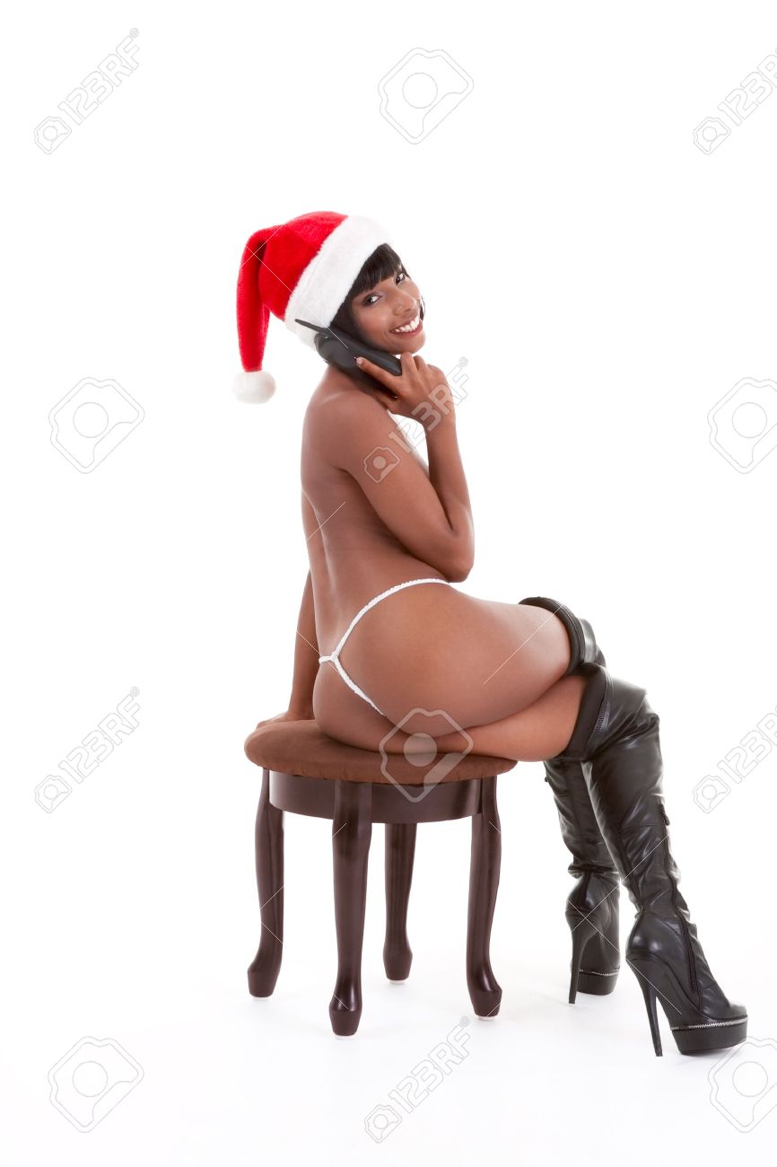 Sensual Naked Erotic Ethnic Black Woman In Mrs Santa Claus Costume And Santa Hat Talking On Sex Phone Stock Photo, Picture and Royalty Free Image image