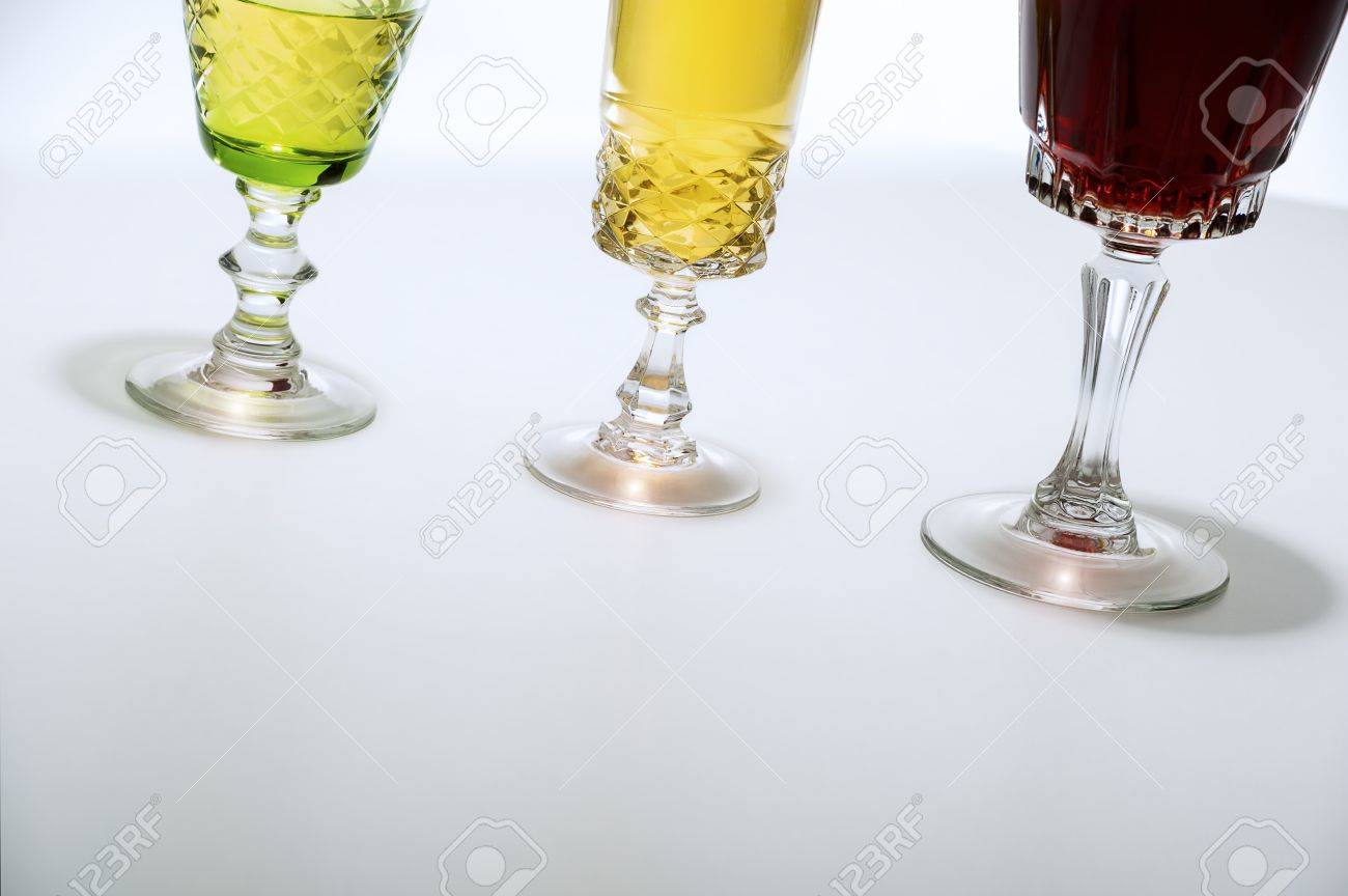 Low Angle Crop On White Background Of Three Cut Glass Wine Glasses