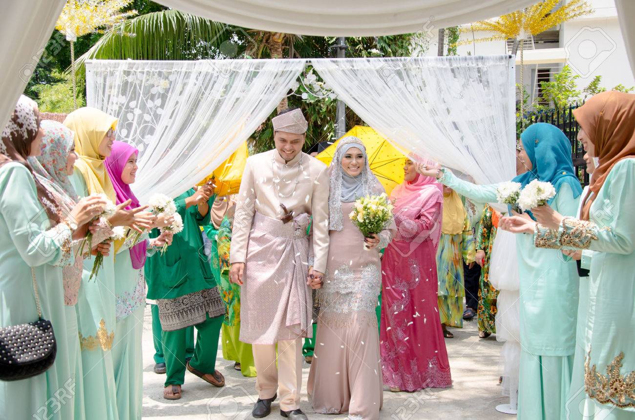 Kuala Lumpur Malaysia March 22 2014 Just Married Malay Couple Walking And Holding Hands Is Being Congratulating By Their Guests Stock Photo Picture And Royalty Free Image Image 49316201