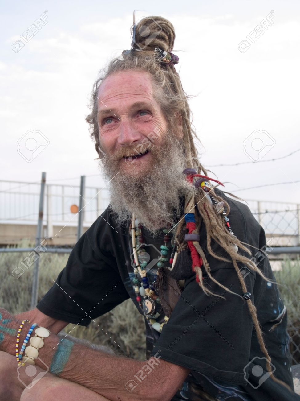 5811598-happy-older-gentleman-with-his-dreadlocks-on-a-bun.jpg