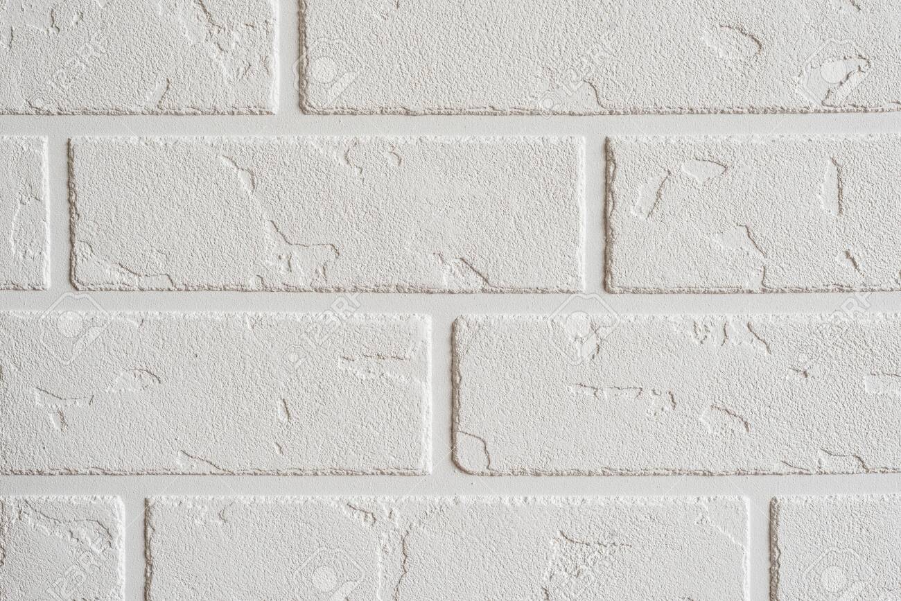 Textured white background. Decorative concrete coating imitating a brick wall. Textured wall plaster, exterior facade. - 152170018 Textured white background. Decorative concrete coating imitating a brick wall. Textured wall plaster, exterior facade. - 152170018