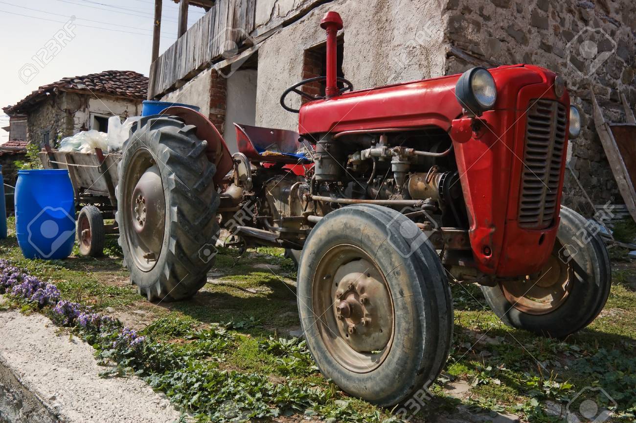 Old Farm Tractor With A Wooden Trailer In Village Stock Photo Old Farm Tractor With A Wooden Trailer In Village Stock Photo