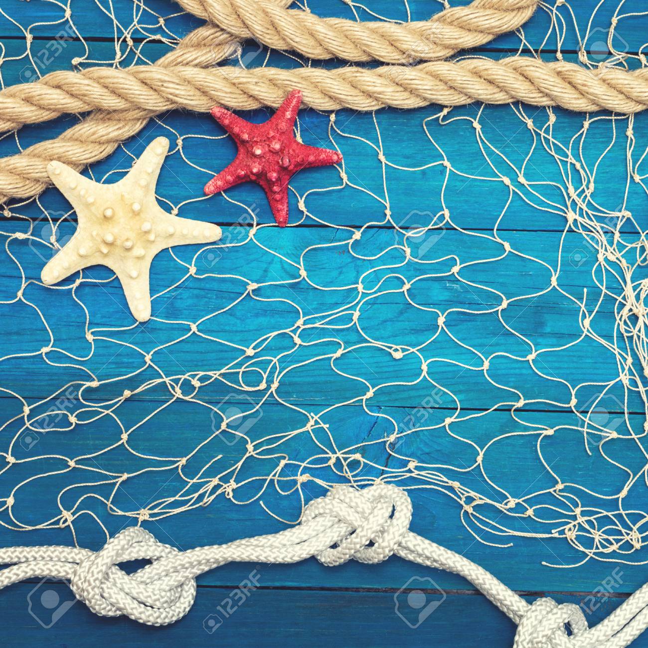 Starfish and seashell on a blue wooden background - 96366031 Starfish and seashell on a blue wooden background - 96366031