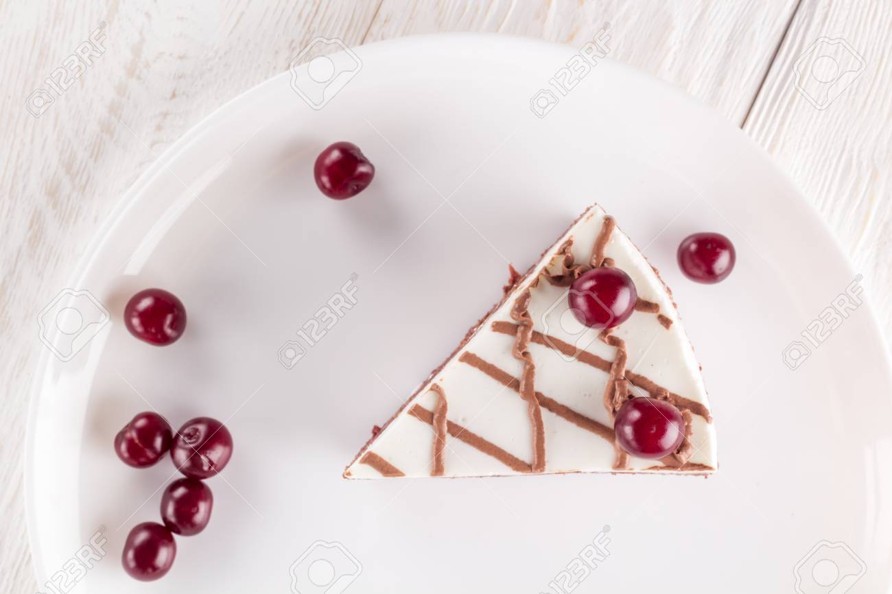 Piece of chocolate cake on plate decorated cherries and chocolate - 98555850 Piece of chocolate cake on plate decorated cherries and chocolate - 98555850