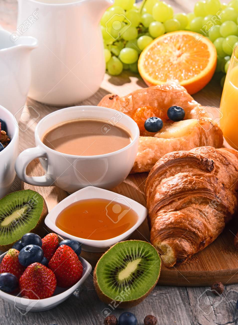 Breakfast served with coffee, orange juice, croissants, cereals and fruits. Balanced diet. - 80751931 Breakfast served with coffee, orange juice, croissants, cereals and fruits. Balanced diet. - 80751931