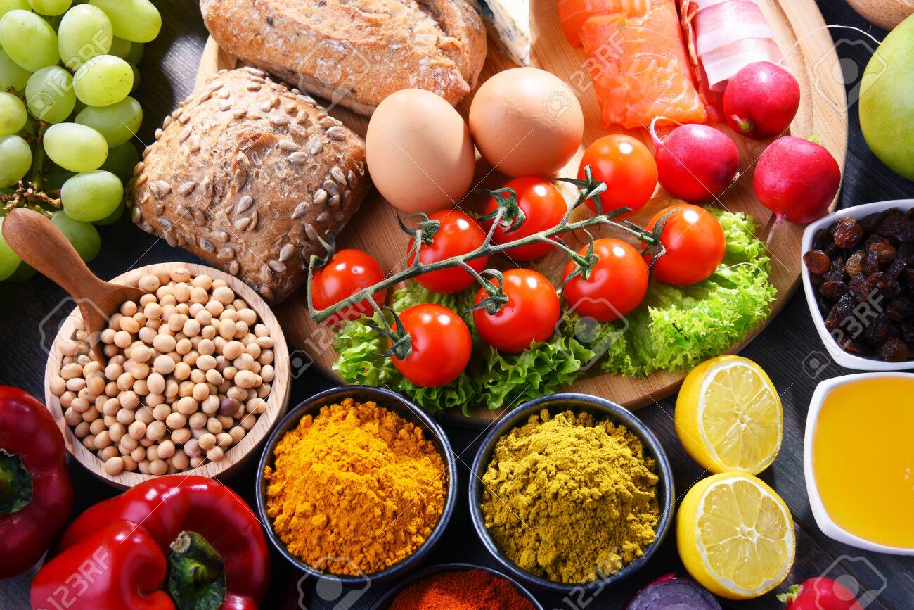 Composition with assorted organic food products on wooden kitchen table. - 123722580 Composition with assorted organic food products on wooden kitchen table. - 123722580
