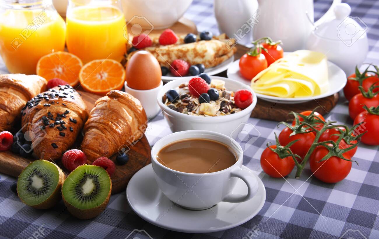 Breakfast served with coffee, orange juice, croissants, pancake, egg, cereals and fruits. - 135302334 Breakfast served with coffee, orange juice, croissants, pancake, egg, cereals and fruits. - 135302334