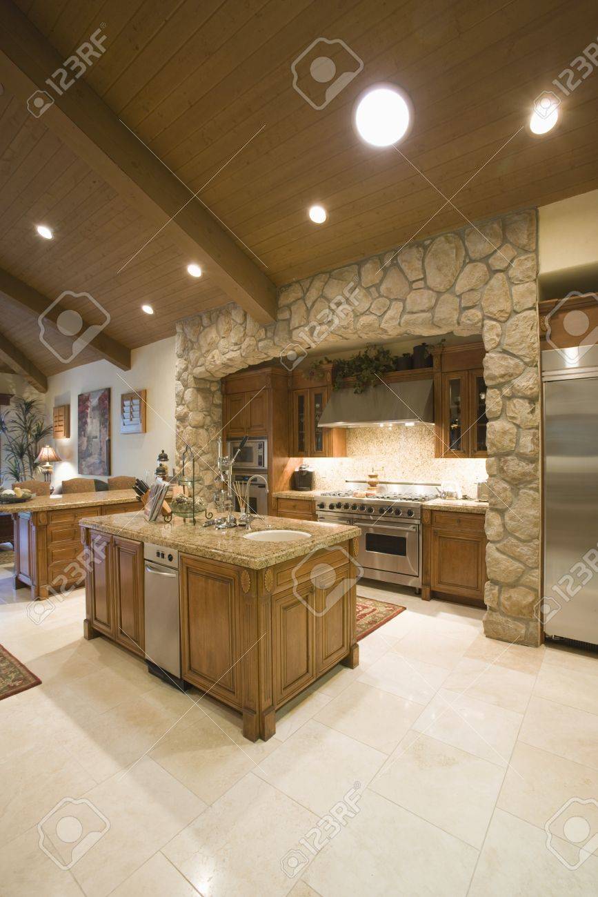 Exposed Stone Kitchen Surround With Spotlights On Wooden Ceiling