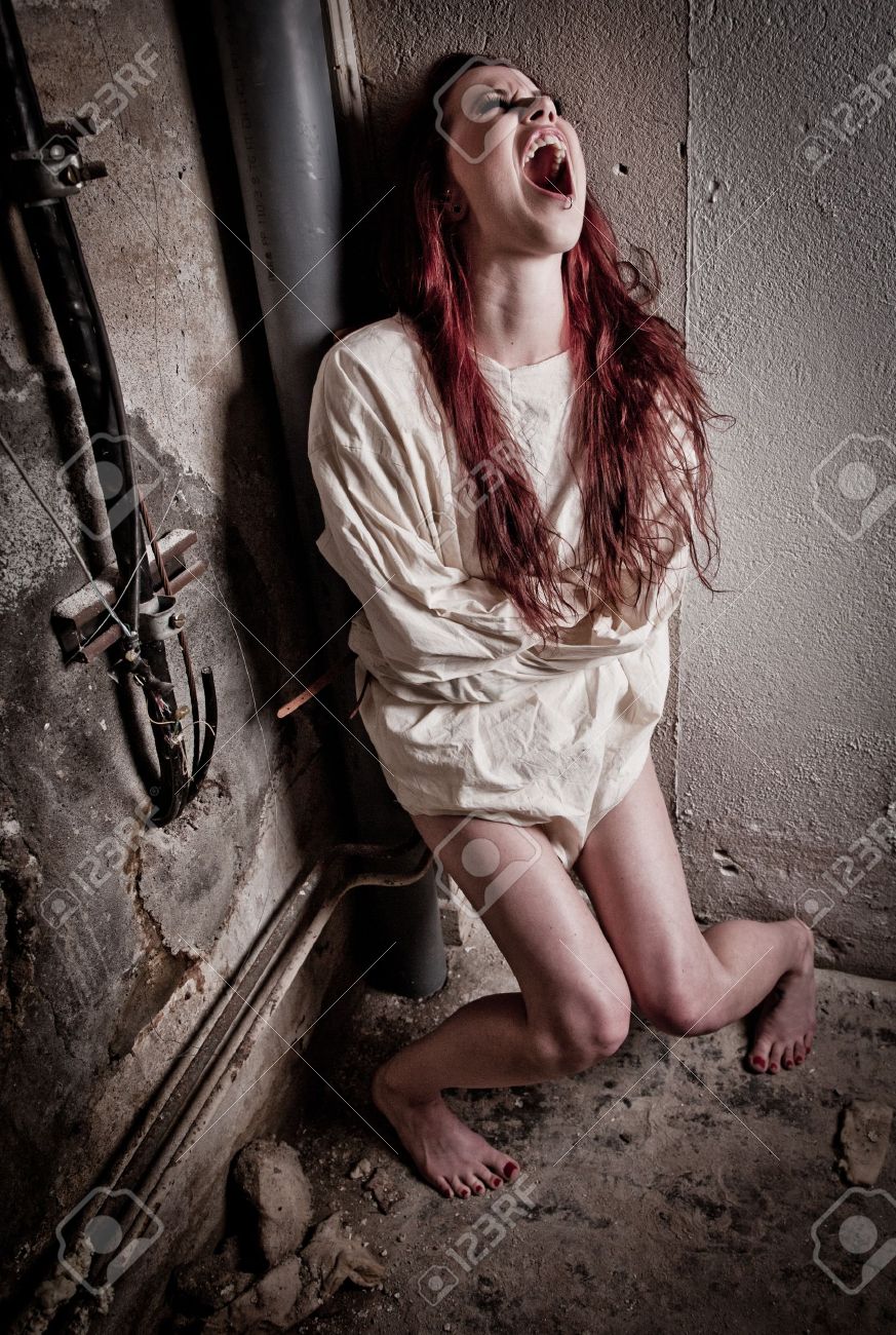 an insane psycho girl wearing a straight jacket stock photo picture